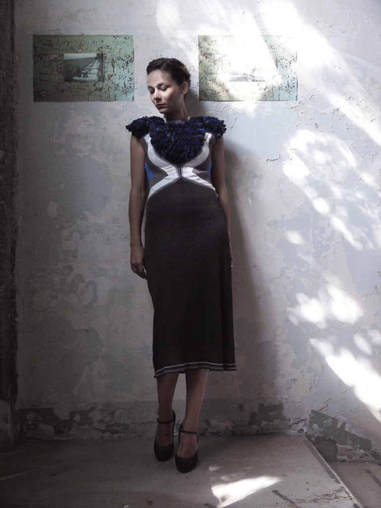Teddy Bear Dress. Knitwear dress,with Abstract Teddy Bear face over the bust and top shoulder which is hand woven in texture wool. The dress is colour blocked in white, blue brlwn and black, creating a chevron, geometric detail