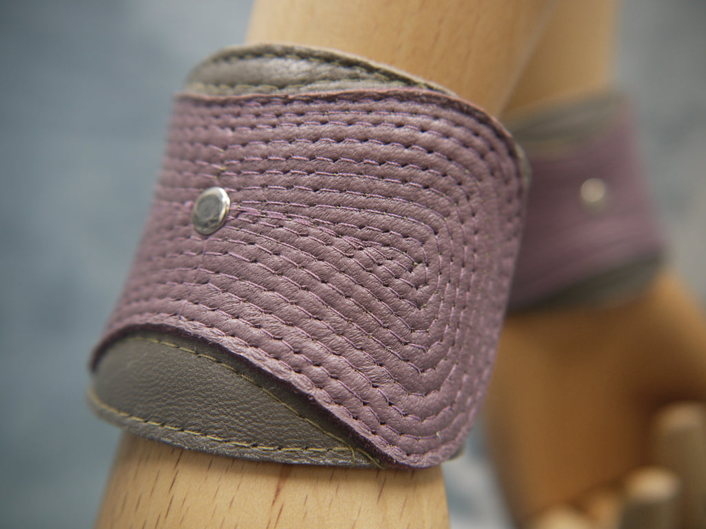 Stitched leather cuff with concentric stitch detail in mauve and moss green