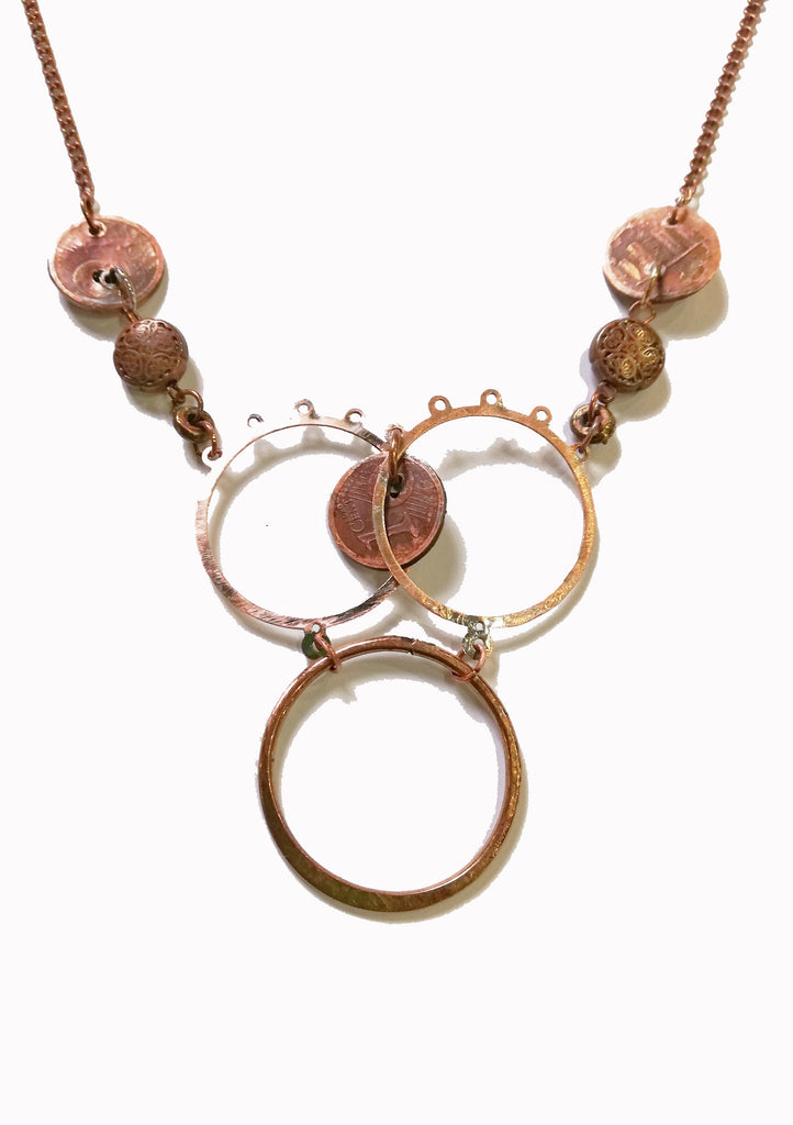 The Heaven Cent Necklace is a unique design in copper and silver.  Inspired by the unsettlement in Europe, the euro cents, which have been individually hand beaten  and oxidixed become the focal point of the design. 