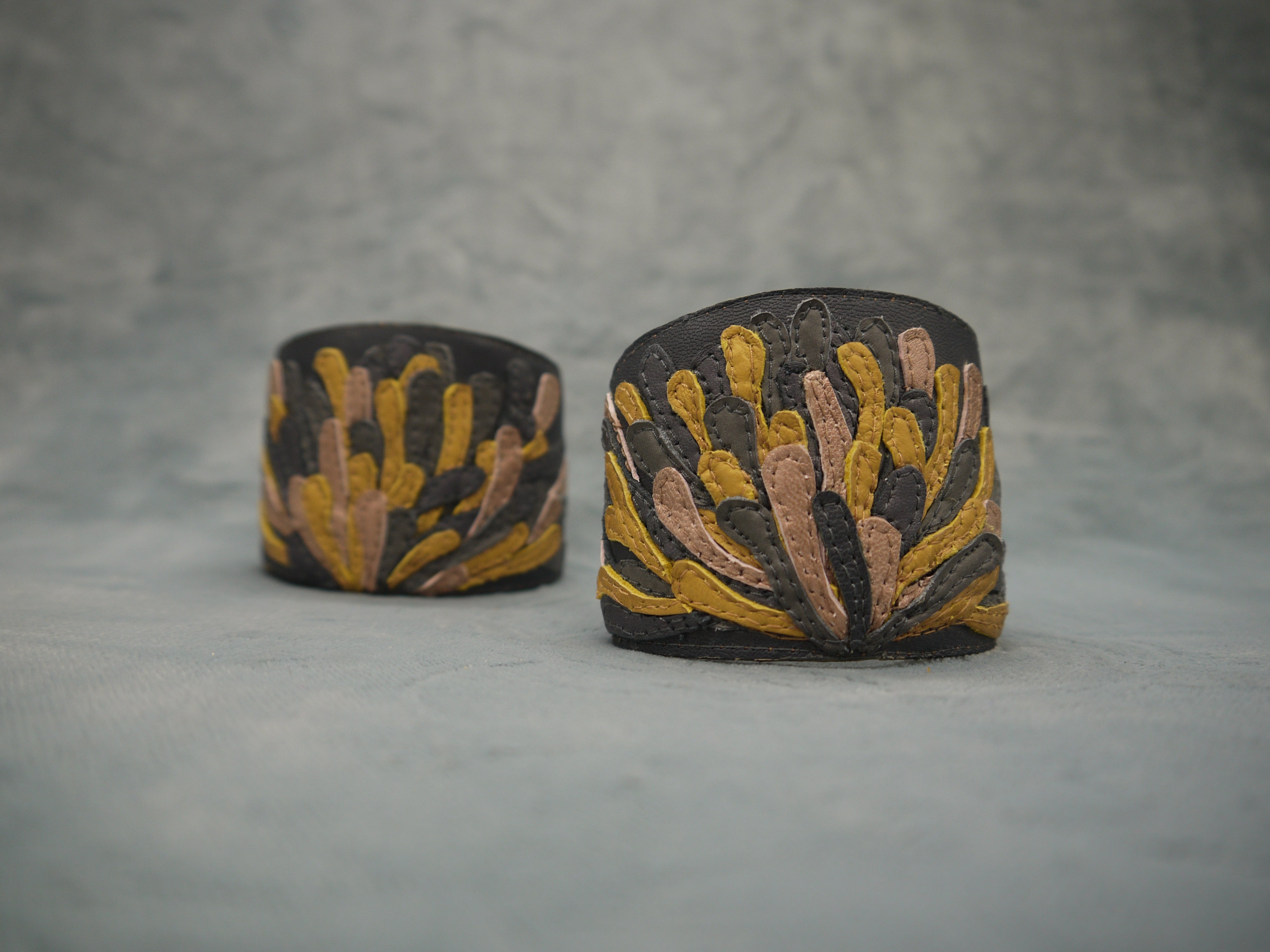 Chysanthemum Leather Cuff in anthracite grey with hand cut petals in sunshine yellow, pale bronze and grey , one-of-a- kind, unique, made in Italy by designer-makers