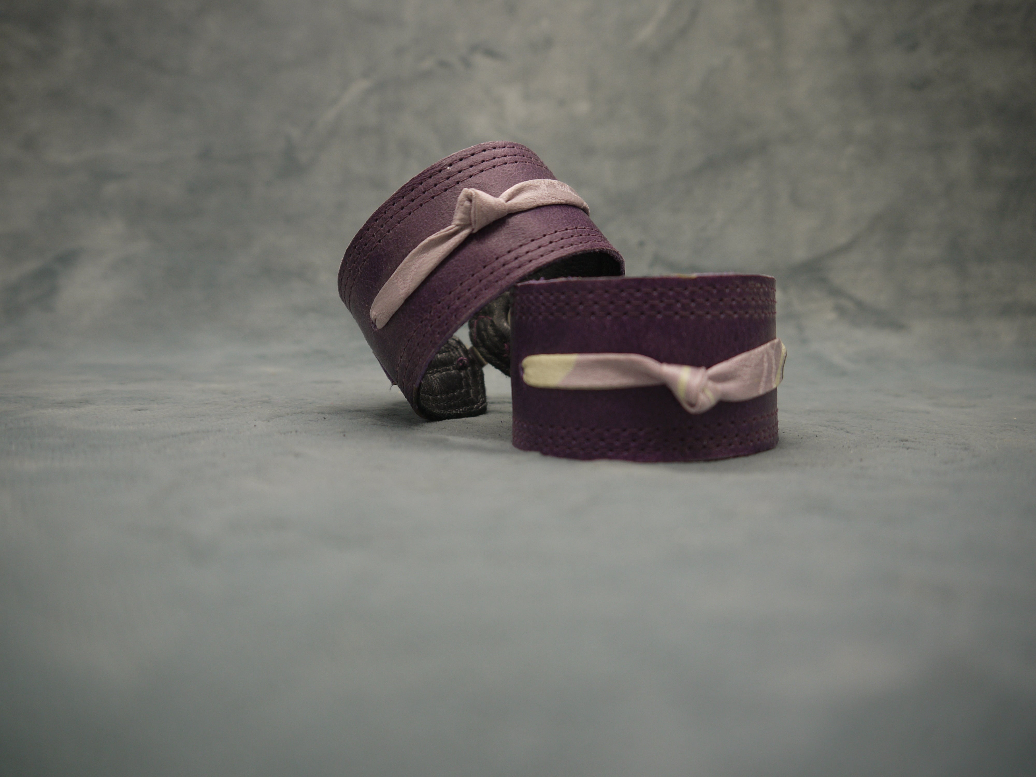 Royal Purple slimline Italian leather cuff with lilac slim silk knot central on the cuff. The cugff has elegant repeat stitch detail around the edges. Close-Up Image