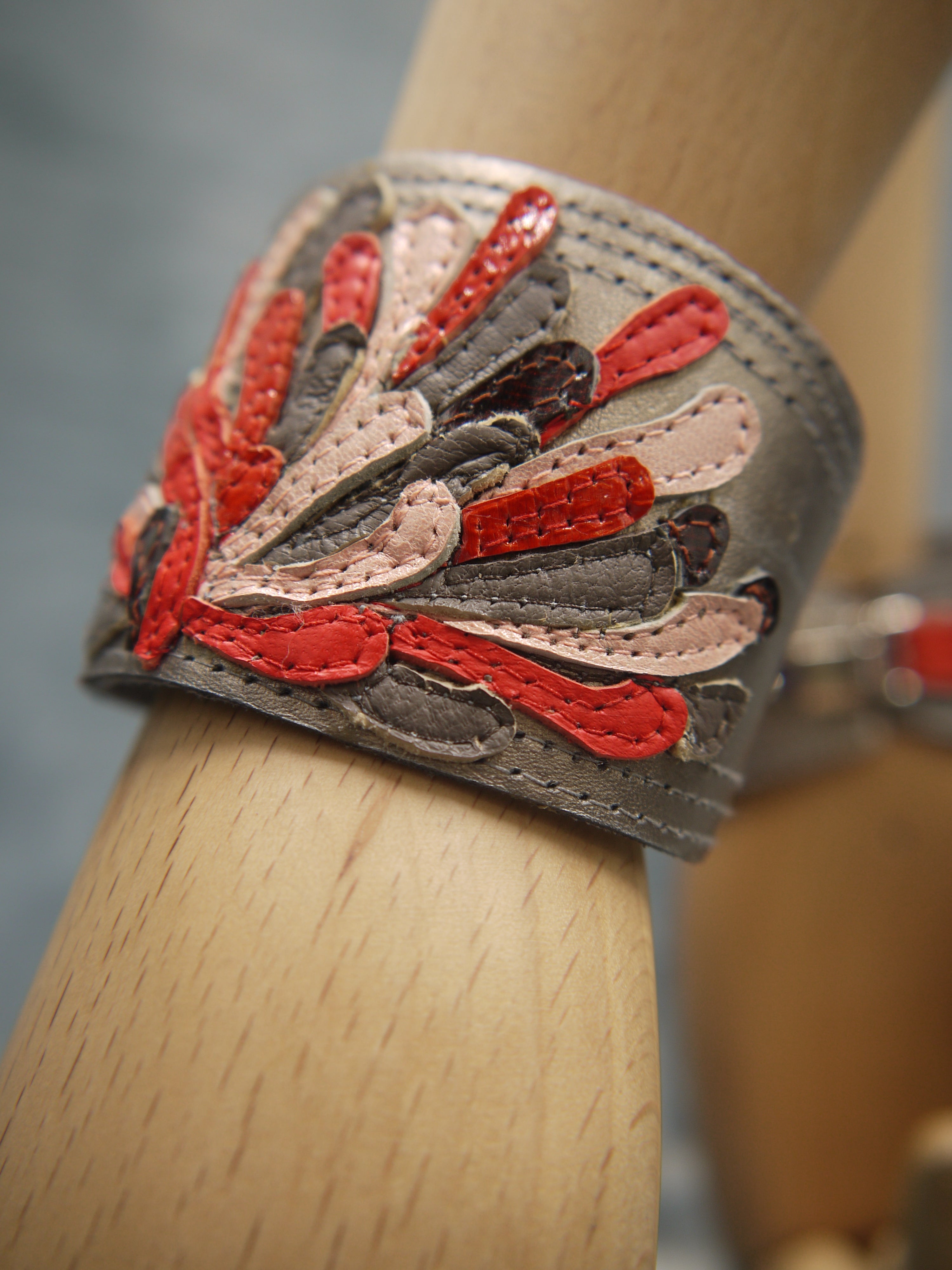 Chysanthemum Leather Cuff with hand-cut petals in vermilion, brown and pale pink, one-of-a- kind, unique, made in Italy by designer-makers.Close up